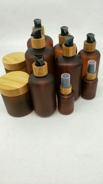 Cheap Amber boston round PET plastic bottle bamboo packaging cosmetics and body lotion in stock for sale